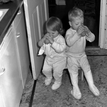 Brother and sister drinking in kitchen Canvas Art - (18 x 24)