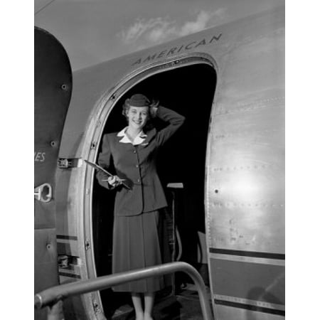 Young woman standing in aiplane door and smiling Canvas Art - (24 x 36)