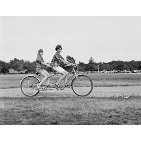 Teenage boy and teenage girl riding a tandem bicycle Poster Print