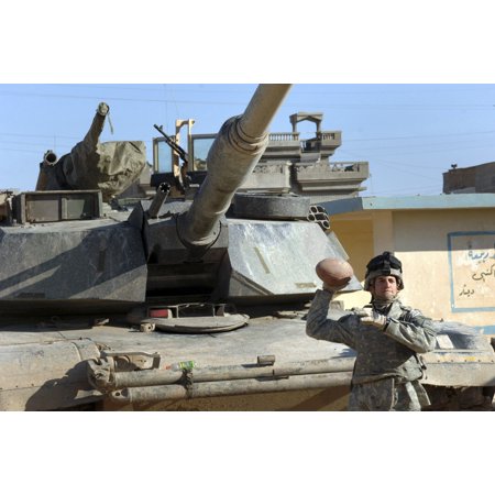 US Army soldier tossing a football around with fellow soldiers prior to a combat patrol in Tall Afar Iraq Stretched Canvas - Stocktrek Images (34 x 23)