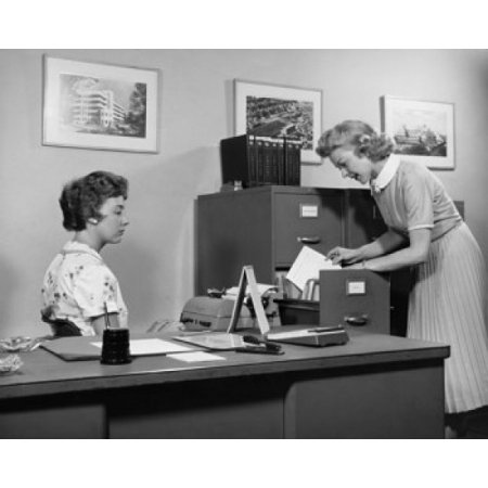 Side profile of two businesswomen working in office Stretched Canvas - (18 x 24)