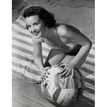Portrait of young woman smiling on beach Poster Print