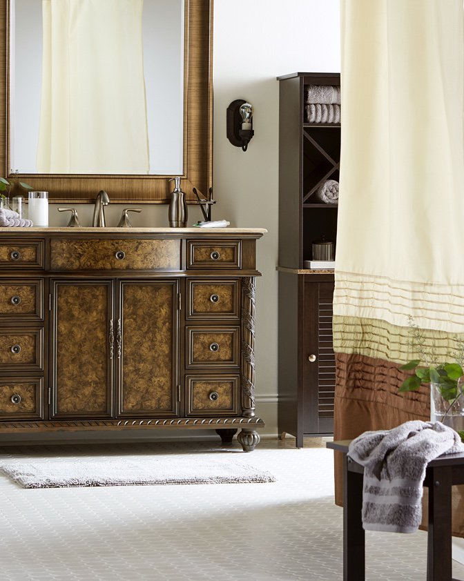 A traditional bathroom with wooden cabinetry.