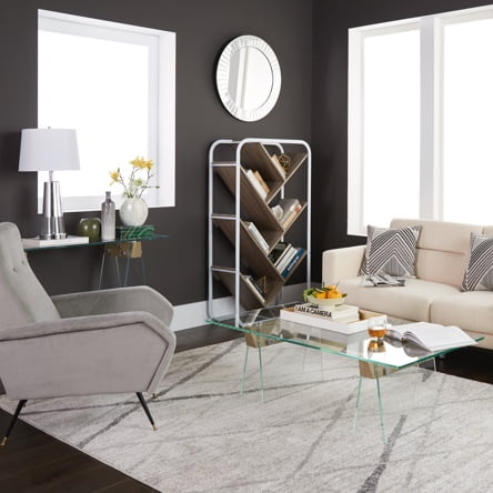 A modern living room with a gray modern accent chair, beige modern sofa, glass coffee table and modern geometric bookshelf.