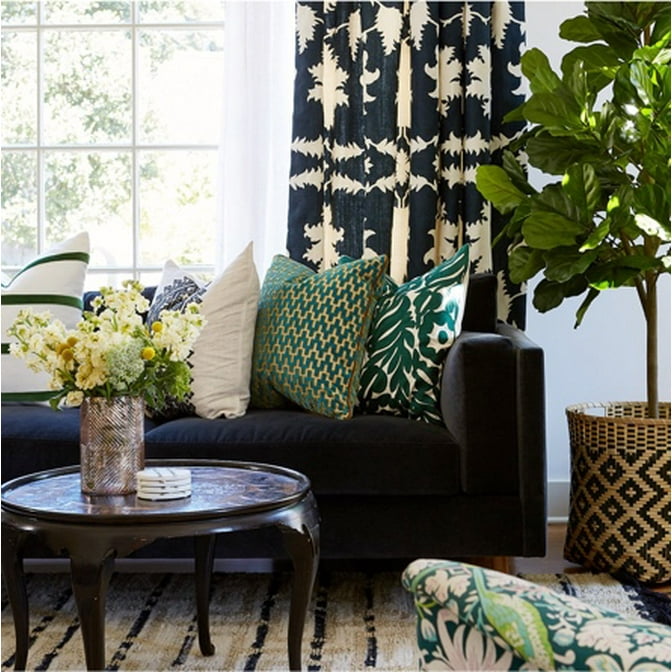 An eclectic living room designed by Carolyn Rebuffel of Workroom C with lots of dark colors and patterns