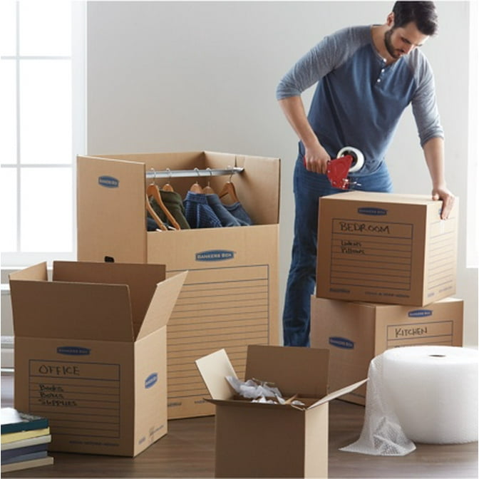 A man packing boxes to move. Starts an article about how to pack for moving.