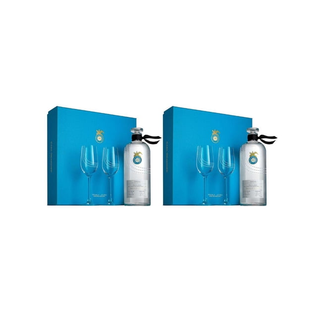 pack de 2 tequila casa dragones joven 750 ml + 2 copas set con dos botellas Casa Dragones Joven 750 ml y dos copas; vista frontal de cada set mostrando botellas blancas cilíndricas con etiqueta plateada y cinta negra en el cuello, dos copas de tallo largo y caja de regalo azul con logo dorado sobre fondo blanco, adecuado como set para degustación o regalo.