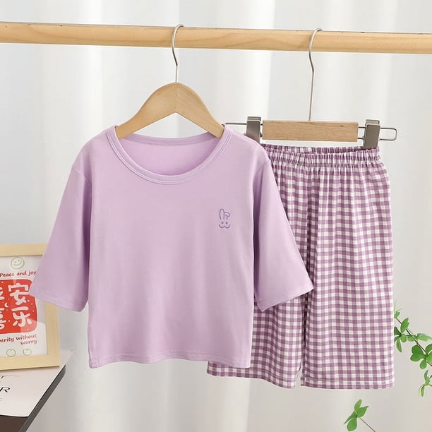 Una familia de cuatro padres e hijos usan ropa de hogar modal con aire acondicionado, pijama de pantalones cortos a cuadros de manga tres cuartos para niños medianos y grandes.