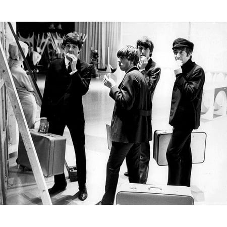 The Beatles eating behind the scenes of a television set Photo