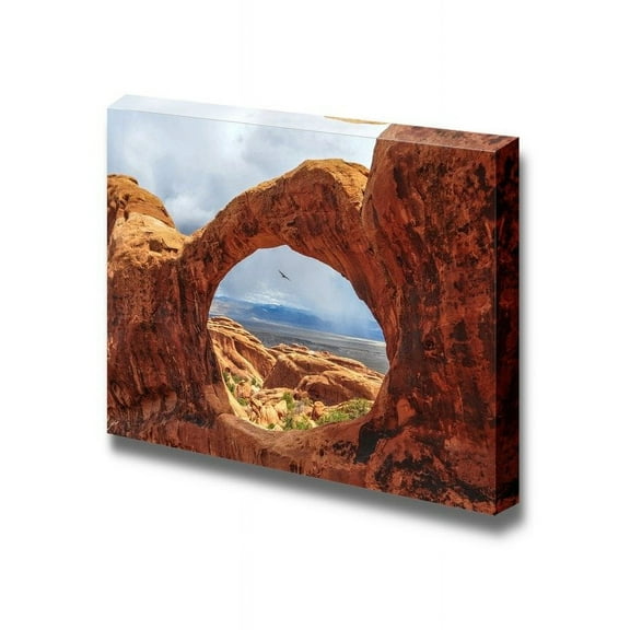 Beautiful Scenery Landscape Bird Flying Through The Top O of Double O Arch in Arches National Park Utah - Canvas Art Wall Art - 12" x 18"