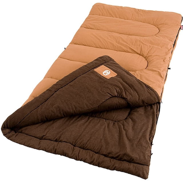 saco de dormir dunnock cold weather coleman sdcd063241660 cómodo suave cálido hecho de poliéster duradero para adultos café vista 3/4 de saco rectangular color café con extremo abierto que muestra forro de franela interior y acolchado con construcción Fiberlock, cierre lateral ZipPlow y etiqueta Coleman; dimensiones 75 x 33 pulgadas (187 x 82 cm), rendimiento térmico hasta 20 °F; a menudo usado para acampar y viajes al aire libre.