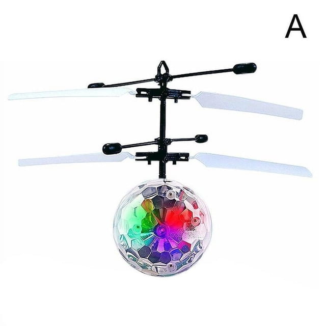 juguetes para niños pelota voladora led 5 6 7 8 9 10 11 años niños geniales edad — Pelota voladora LED bola cristal rota, vista frontal centrada; esfera translúcida de 12 cm x 14.5 cm con luces LED multicolor encendidas, doble rotor y palas de plástico, sensor de inducción en la base y cable USB incluido; a menudo usada para practicar coordinación mano‑ojo al aire libre.