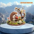 thumbnail image 4 of Rotating acrylic ornament featuring a colorful hedgehog enjoying an apple amidst detailed grass and vibrant flowers. Perfect decorative piece, 4 of 7
