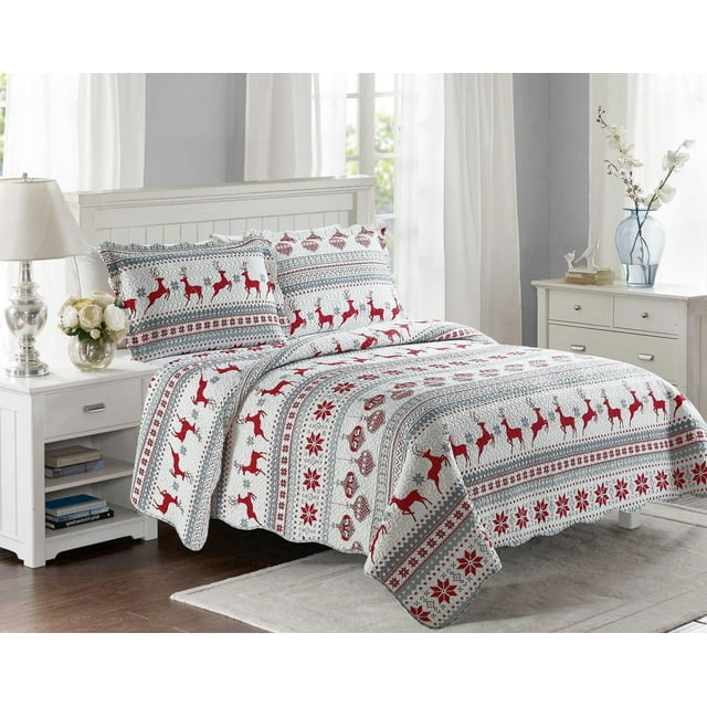 white bedspread and pillow shams with embossed texture, decorated with red reindeer, snowflakes, and geometric patterns in a bright bedroom setting