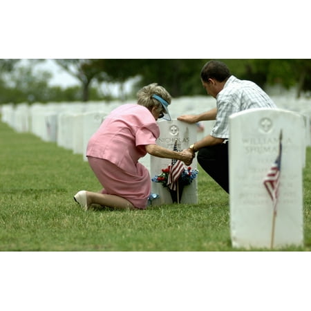 San Antonio Sites May 28 2006 - A mother and her son hold hands and pray at her fathers grave site at Fort Sam Houston National Cemetery in San Antonio Poster Print ()