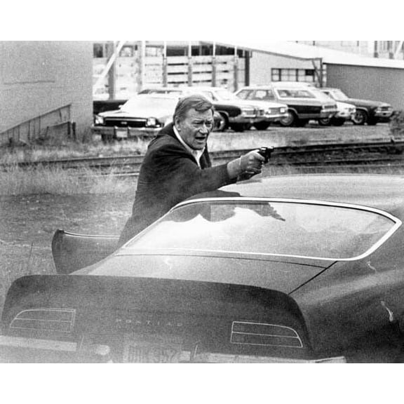 John Wayne takes aim with gun over his Pontiac Grand-Am 1974 McQ 5x7 photo