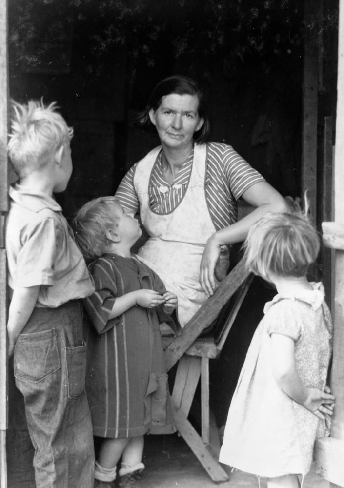 Oklahoma Squatters, 1935. /Na Woman With Her Children At The Entrance
