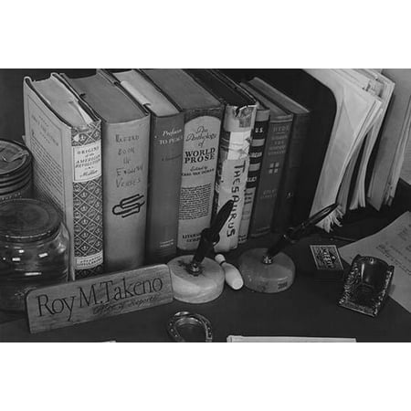 Books a name plaque fountain pens a box of matches and paper files on top of desk  Ansel Easton Adams was an American photographer best known for his black-and-white photographs of the American