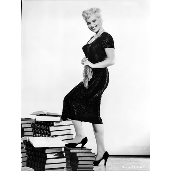 Judy Holliday on a Dress and One Leg on Stack of Books Photo Print (8 x 10)