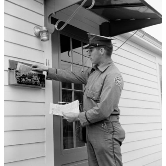 Side profile of a postman dropping mail in a mailbox Canvas Art -  (24 x 36)