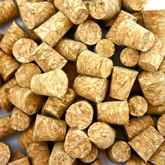 BodyJewelryOnline 100 pcs small body piercing corks for needles, made of natural material, shown in a close-up view. The corks are cylindrical, measuring 3/8 inch (10 mm) by 5/8 inch (16 mm), ideal for use as stoppers for jewelry studs, piercing tools, or body jewelry accessories.