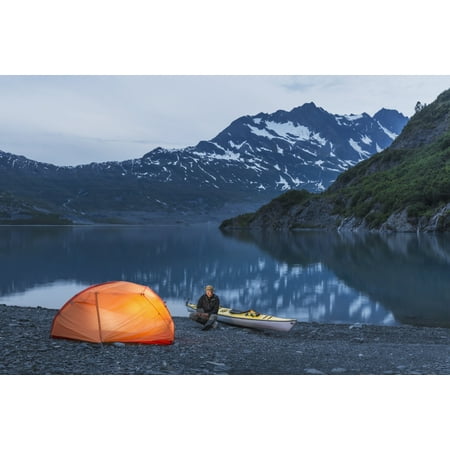 Man reading on a electronic tablet while camping with a tent and kayak at Shoup Bay State Marine Park Prince William sound Valdez Southcentral Alaska Stretched Canvas - Kevin Smith Design Pics (19 x