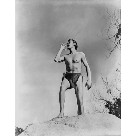 Johnny Weissmuller Shouting on Top of a Big Rock in a Movie Scene Photo