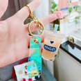 thumbnail image 1 of Lindo llavero de dibujos animados lindo llavero de coche Mini taza de té de la leche cristal líquido arena movediza lentejuelas llavero bolsa colgante para mujer xuanjing unisex, 1 of 2