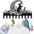 thumbnail image 1 of Perchero de pared de metal con diseño de gato, luna y mariposa, 15,7 x 9,8 pulgadas, con 10 ganchos, diseño de animales, plantas y arte negro., 1 of 9