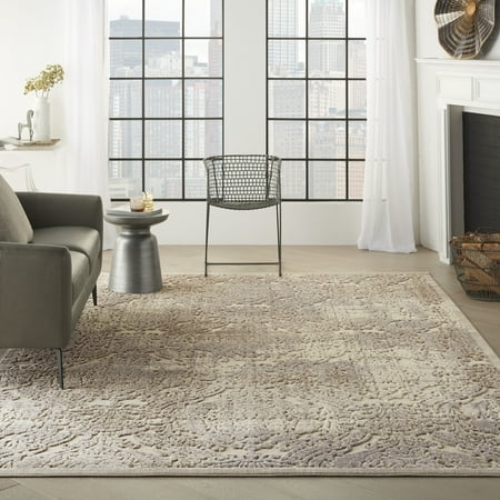 Nourison Graphic Illusions Distressed Damask Ivory 6 7  x 9 6  Area Rug  (7  x 10 ) Striking  bold patterns define this collection of tantalizing rugs. Featuring an exciting hand-carved high-low texture and contemporary color palette  these contemporary area rugs will add a distinctive flair to any setting. Indulge the senses and make a bold statement with these durable and captivating creations. Expert hand carving and a high-low loop pile construction give this area rug extraordinary touch appeal. Sublime shading in subtle gradations of grey and ivory background impart a damask design with an intriguing air that will lend an exotic allure to any setting.