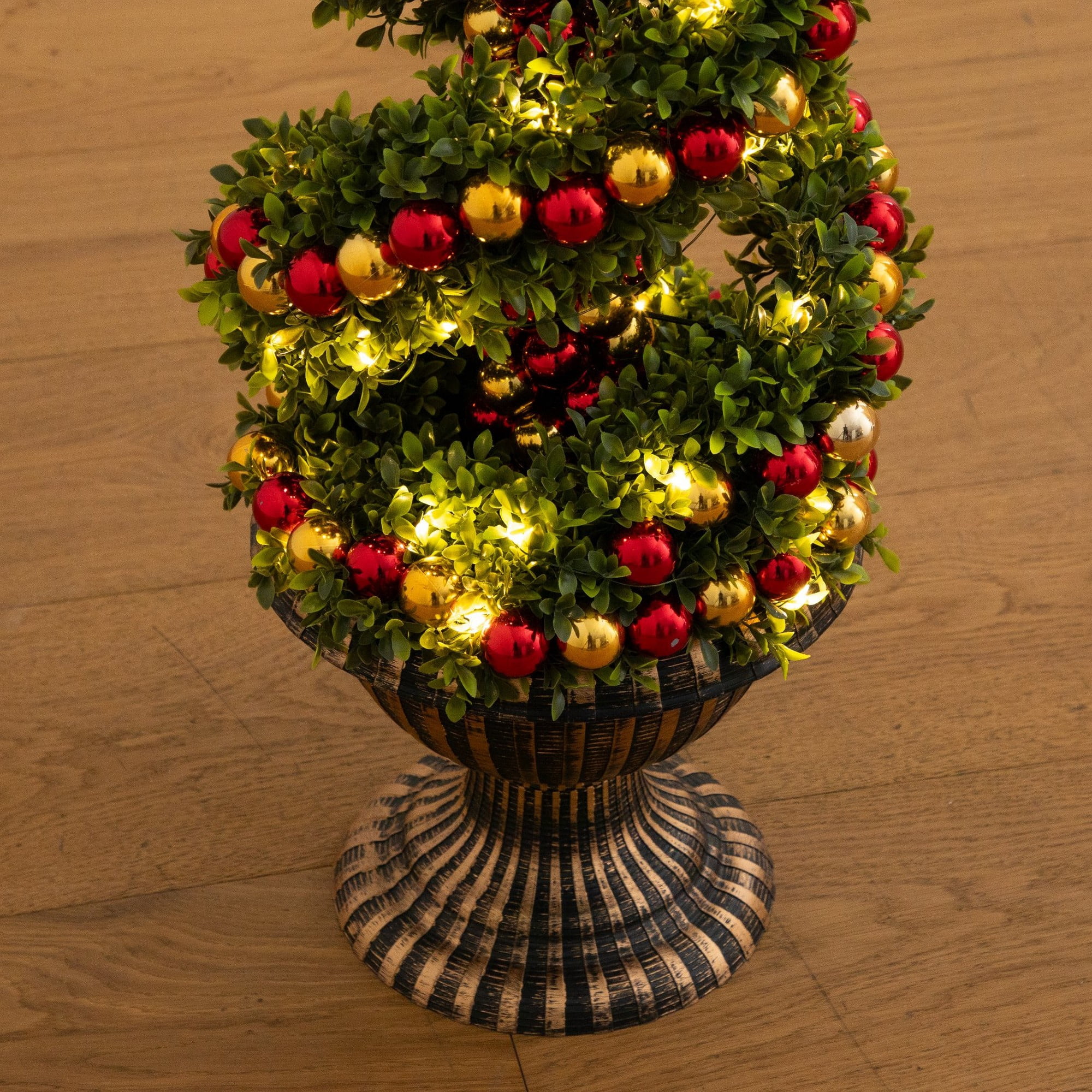 3ft. Pre-Lit Artificial Christmas Spiral Boxwood Topiary Tree with Ornaments and 70 LED Lights in Decorative Urn
