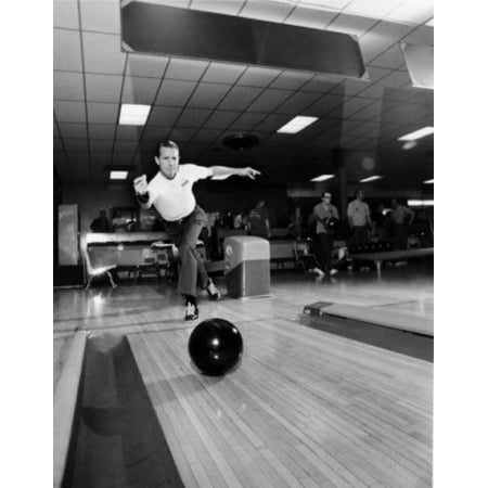 Mid adult man rolling a bowling ball in a bowling alley Canvas Art -  (24 x 36)