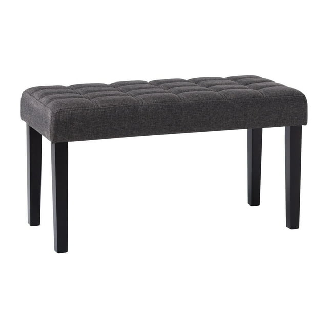 Tufted charcoal gray fabric upholstered entryway bench with four black wooden legs.