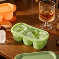 thumbnail image 4 of Molde de cubitos de hielo de silicona con tapa, 3 cavidades, apilable, de grado alimenticio, reutilizable, para congelador, cocina y bar, color verde o naranja., 4 of 6