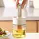 thumbnail image 1 of Dispensador de aceite 2 en 1 con cepillo - Botella dispensadora de aceite de oliva y salsa de vidrio con cepillo de silicona ajustable y tapa de bloqueo for cocinar, asar, freír y salsas, 1 of 5