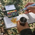 thumbnail image 6 of Funto Mini Watercolor Paint Set, All-in-One 24-Color Travel Paint Kit, with Crossbody Bag, Watercolor Journal, Paint Water Cup, Pocket Set for Artists, 6 of 7