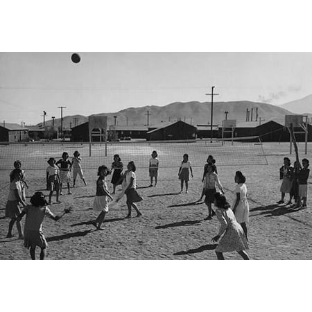 women playing volleyball one-story buildings and mountains in the background  Ansel Easton Adams was an American photographer best known for his black-and-white photographs of the American West 