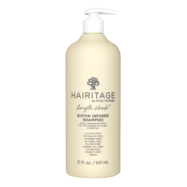 champú hairitage length check biotin con aceite de ricino negro jamaicano, 400 ml botella frontal marfil con dispensador blanco; etiqueta con logo Hairitage y texto 'Biotin Infused Shampoo' y lista de beneficios sin sulfatos ni parabenos visible; formulado para engrosamiento y fortalecimiento, adecuado para rutinas de cuidado capilar.