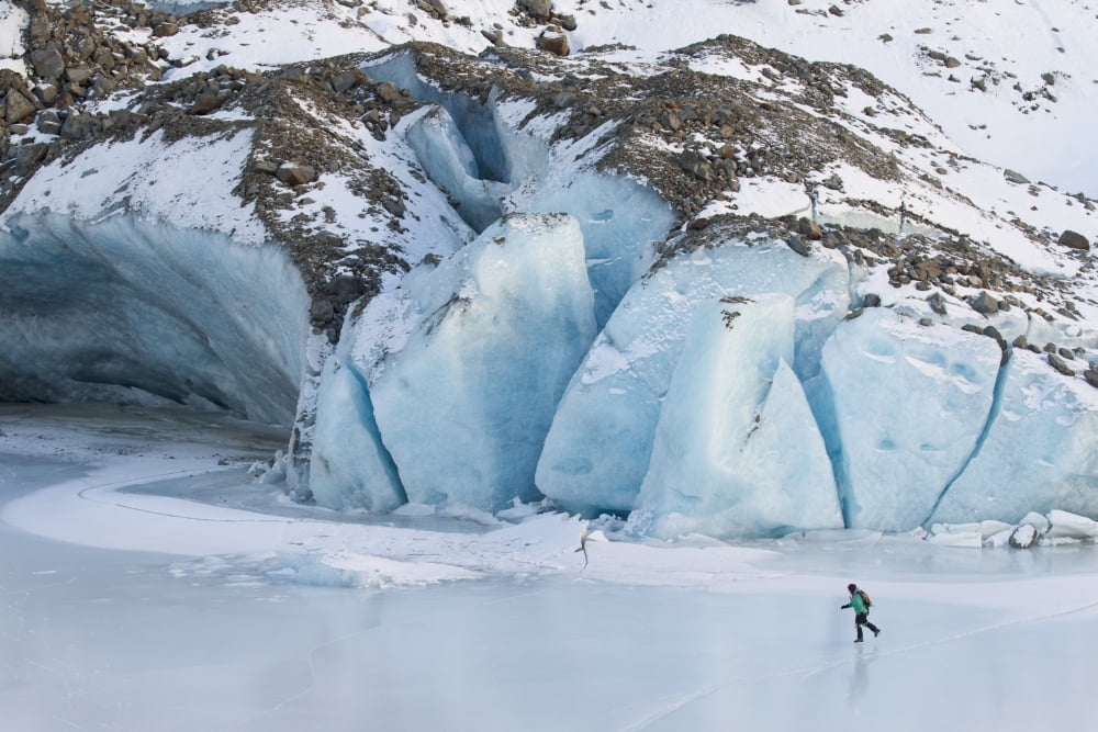 Woman Ice Skating In Front Of Saddlebag Glacier, Chugach Mountains Near