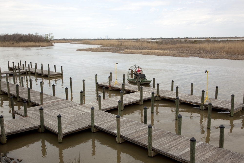 Airboat lands at the dock of the 5 Rivers Delta Center located where