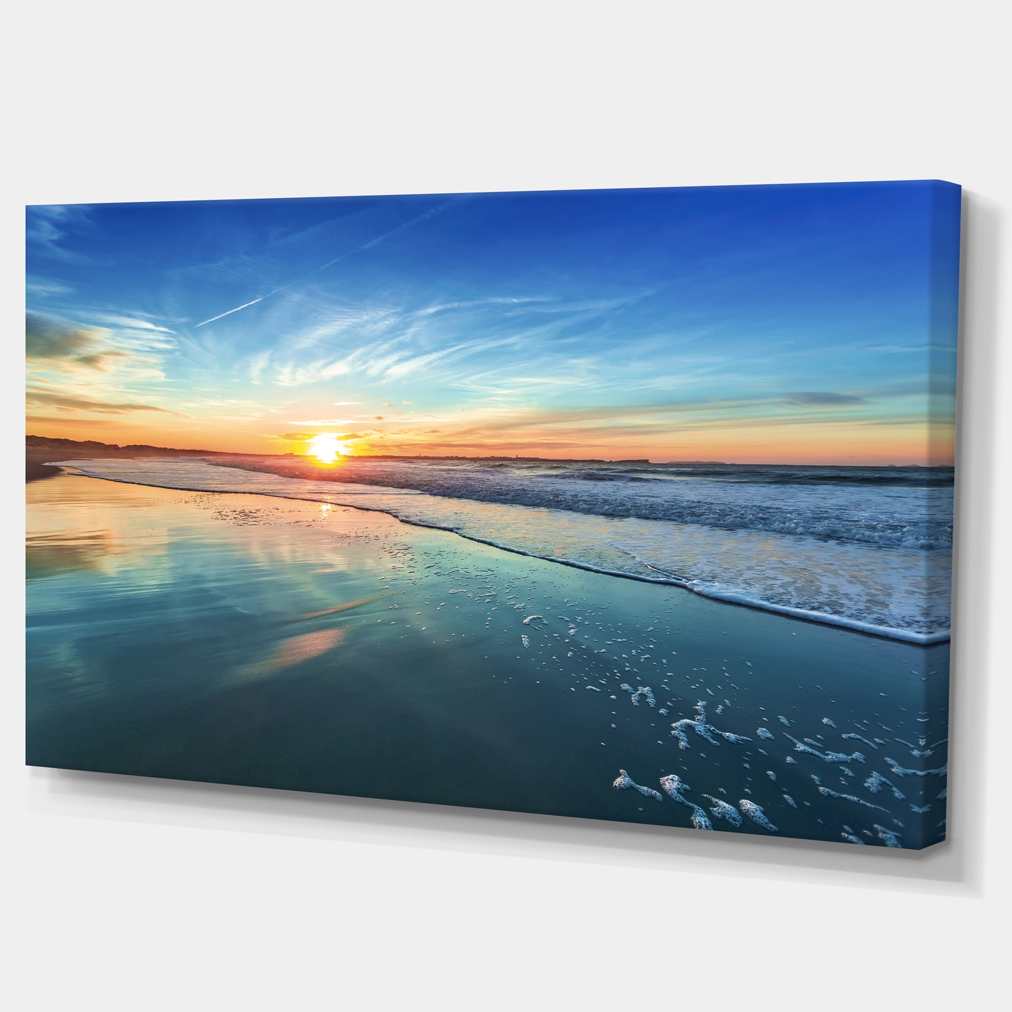 Designart 'Blue Seashore with Distant Sunset ' Seascape Canvas Art Print