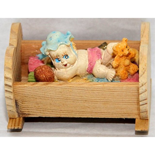 Small Baby Lying In Wooden Heart Shaped Crib Cast Resin Figurine