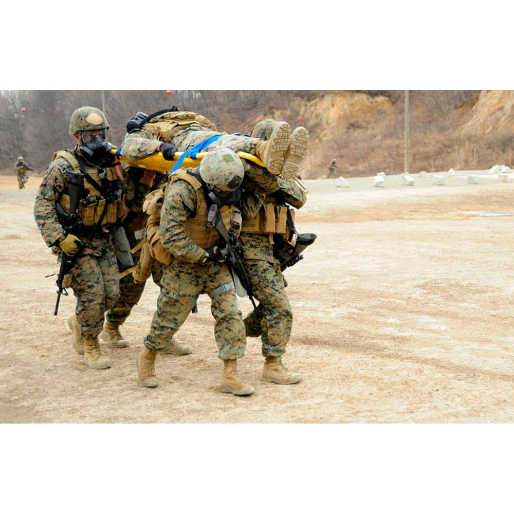 US Marines carry a fellow Marine on a stretcher Poster Print by