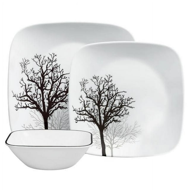 Corelle Timber Shadows 12-piece square glass dinnerware set featuring a black tree silhouette design on white plates and a matching bowl with a thin black rim, service for four.