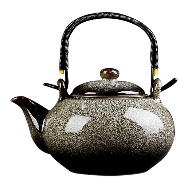 Tetera de cerámica de porcelana con hojas sueltas y asa. gris