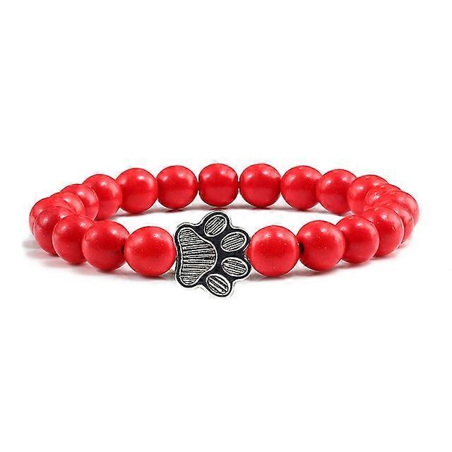 Pulsera con dije de huella de pata de piedra volcánica de lava negra mate natural, ideal como recuerdo para mascotas, amantes de los gatos y los perros.