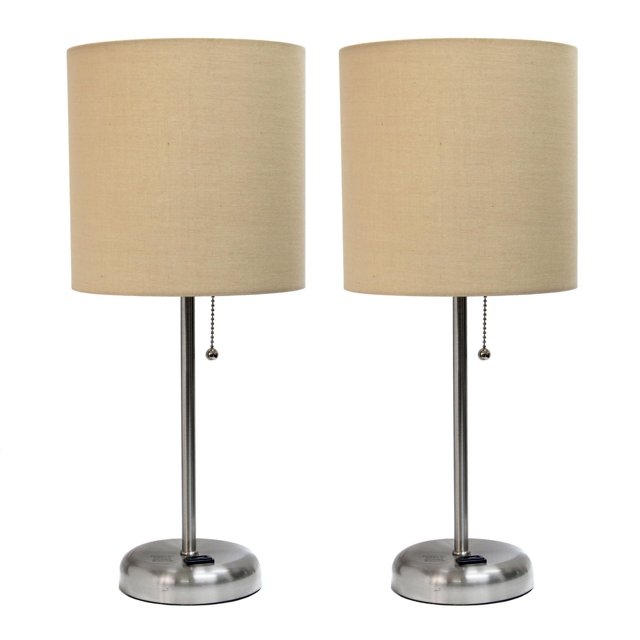 Pair of brushed steel stick lamps with beige fabric shades, pull chain switches, and built-in charging outlets on round bases.