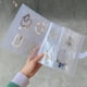 thumbnail image 3 of Almacenamiento transparente Álbum Embalaje Collares Joyería Libro Exposición A prueba de polvo Antioxidación Sellado Bolsas de maquillaje 4 rejillas, 84 rejillas 30 bolsas de almacenamiento Jumpingount CE015142-03, 3 of 6