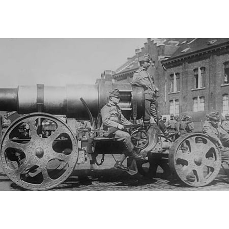 Austrian Army sits astride a large mobile artillery siege gun they are uniformed and bear rifles as they hover around and on  the wheeled cart during World War I Poster Print by