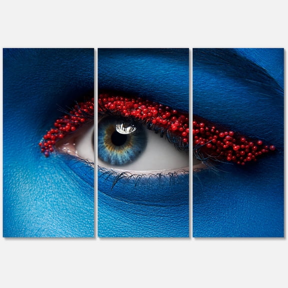 Designart ' Woman Eye With Blue Paint On Face & Red Balls ' Modern Canvas Wall Art Print
